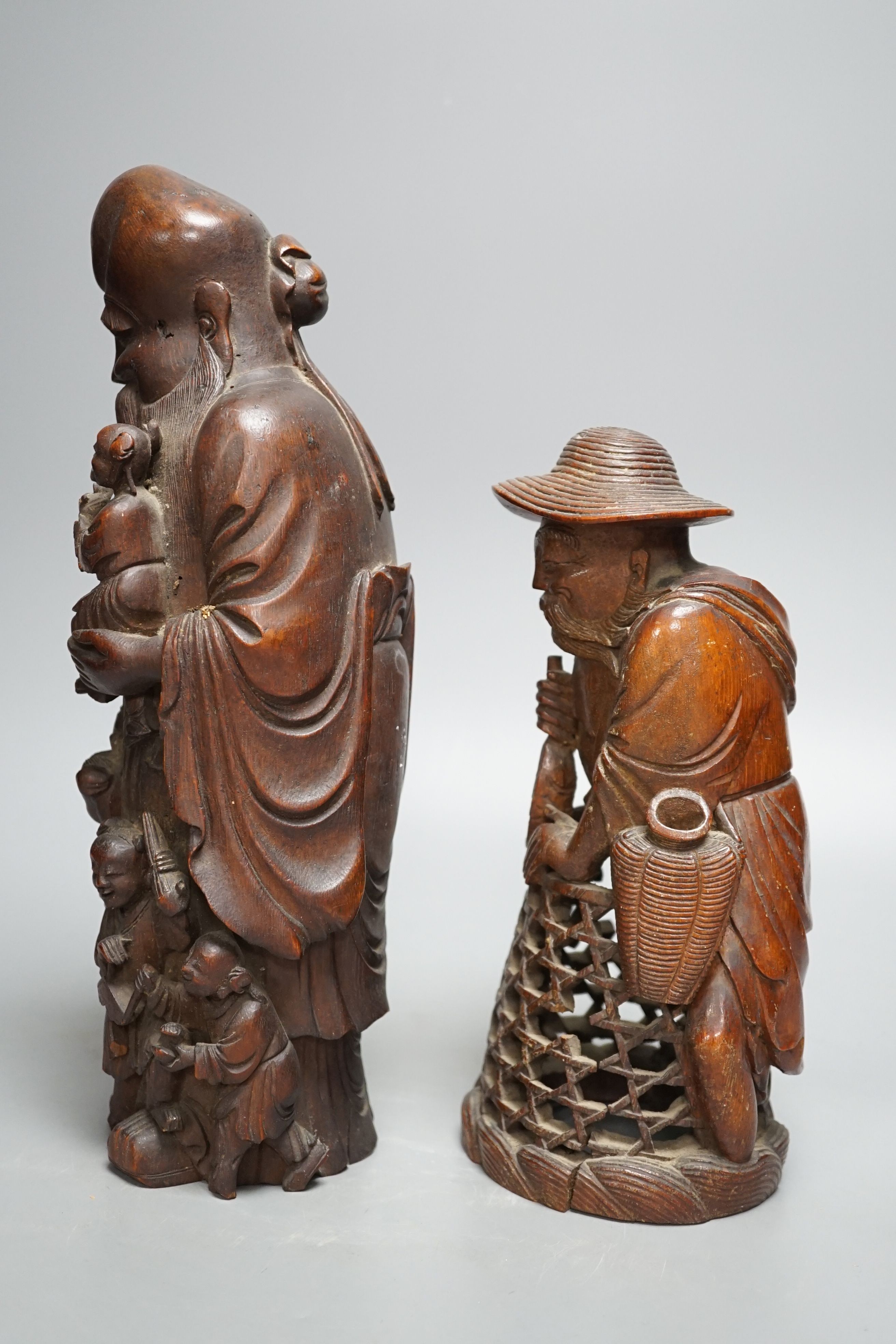 A 19th century Chinese bamboo figure of Shou Lao and a similar bamboo carving of a fisherman, 32 and 25cm, some losses